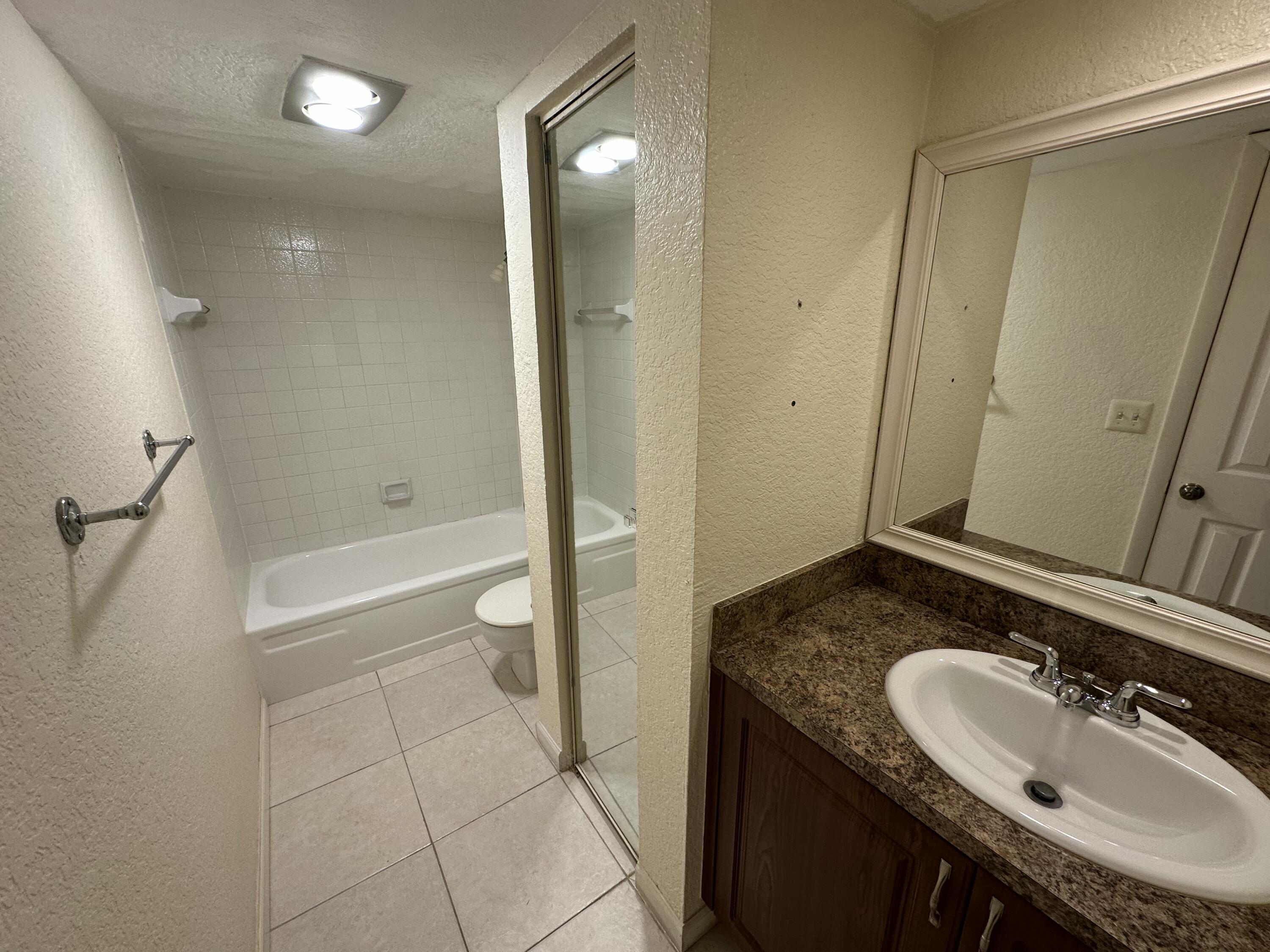 622 Springdale Circle Palm Springs, FL 33461 - Photo 12 of 13 a bathroom with a granite countertop sink a toilet and shower