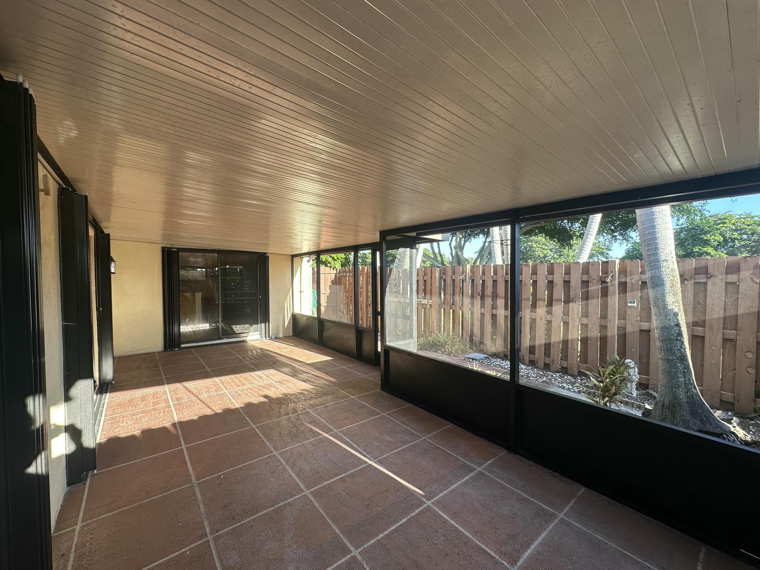 622 Springdale Circle Palm Springs, FL 33461 - Photo 6 of 13 a view of a porch with wooden floor and outdoor space