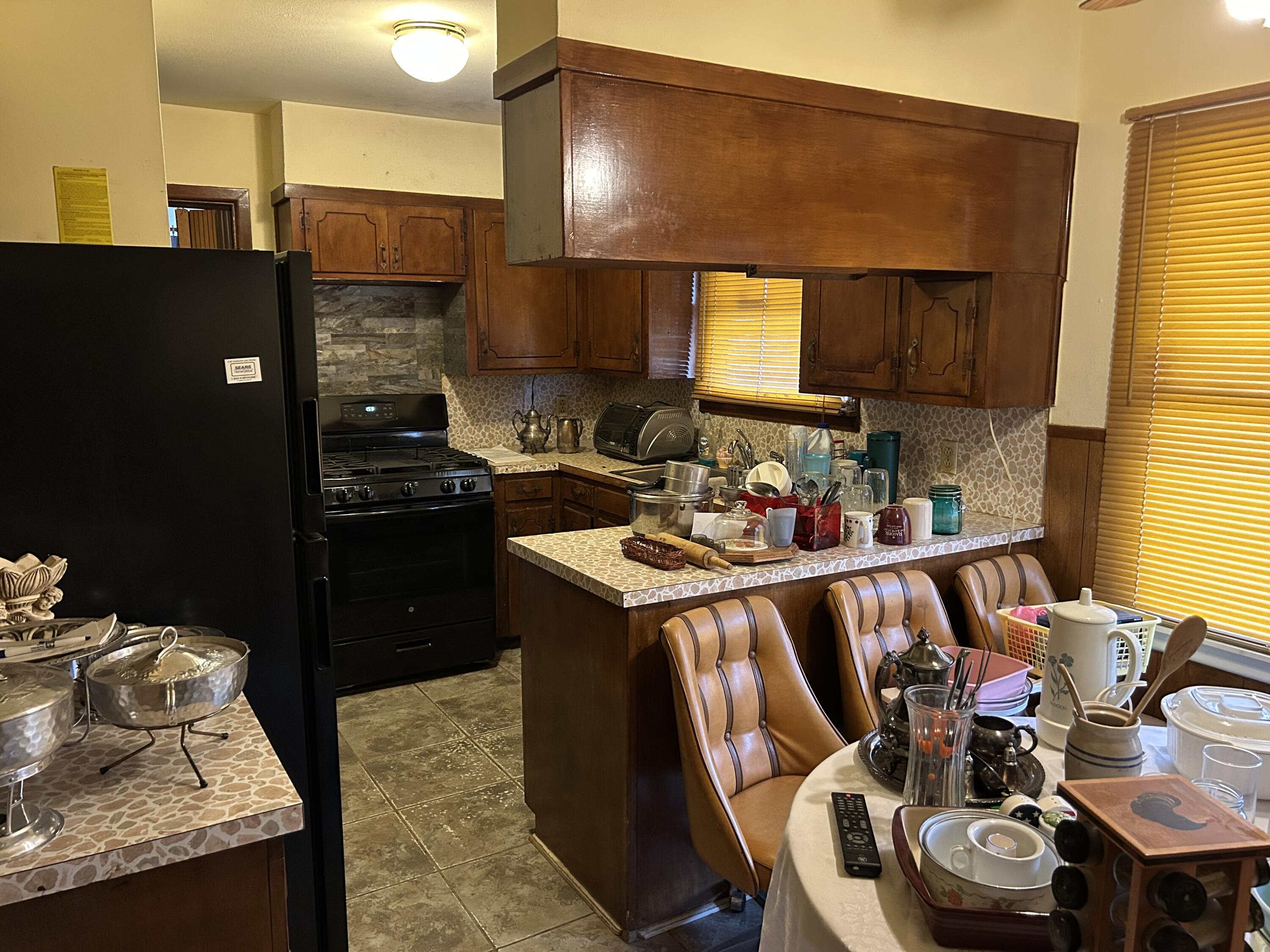 2802 Walnut Avenue Lubbock, TX 79404 - Photo 6 of 13 a kitchen with stainless steel appliances granite countertop a sink stove and refrigerator