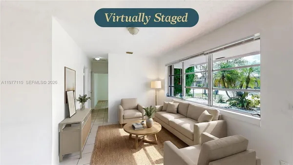 a living room with furniture and a large window