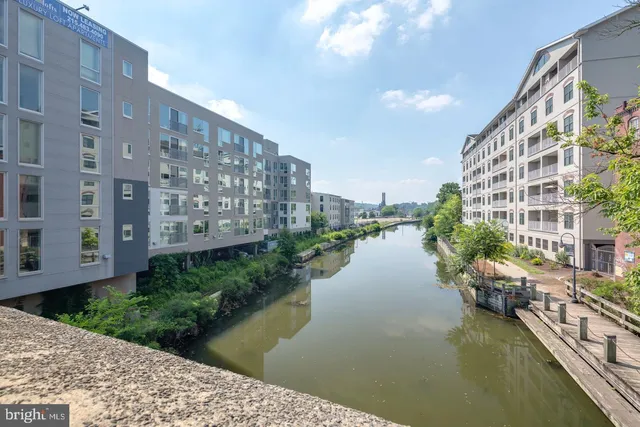 a view of residential building with outdoor space and lake view