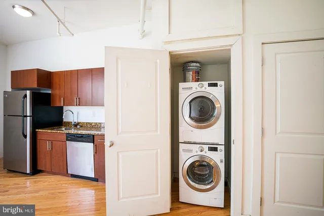 a utility room with sink dryer and washer
