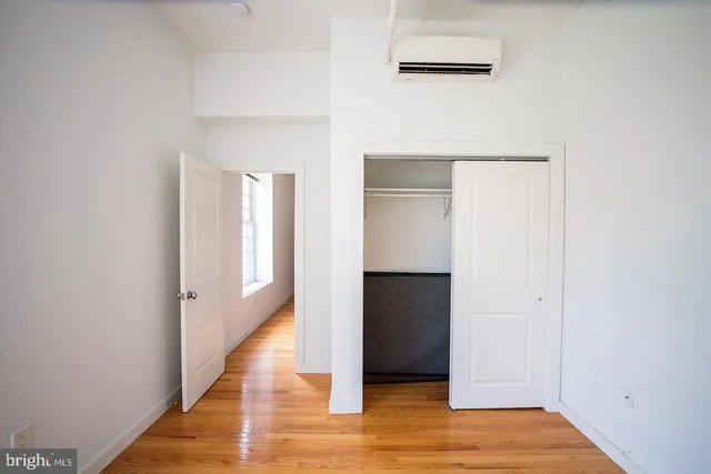 a view of hallway with wooden floor