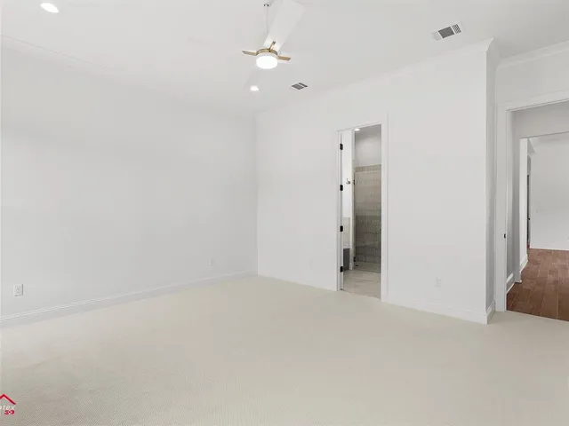 a view of an empty room with a ceiling fan