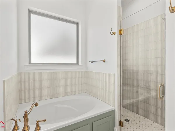 a white bath tub sitting next to a shower