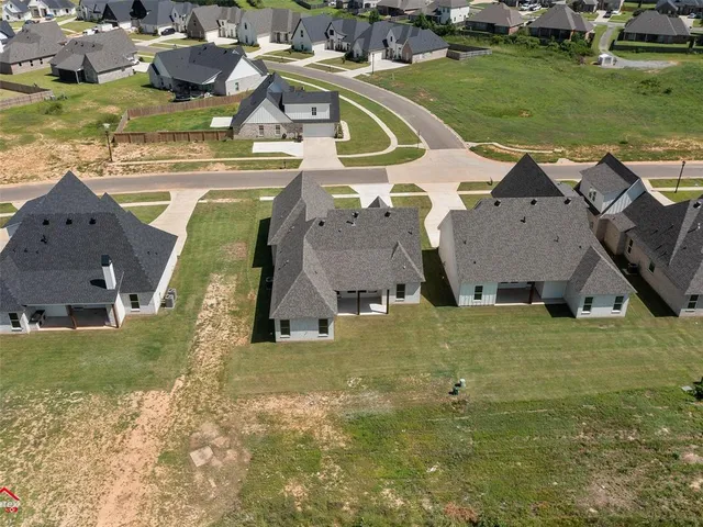 an aerial view of a house with a yard