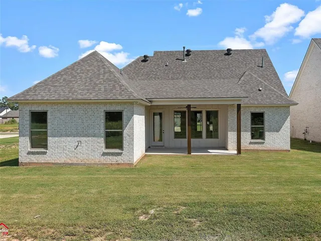 a view of a house with swimming pool and a yard