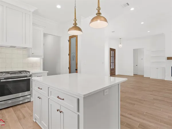 a kitchen with a stove a sink and a refrigerator