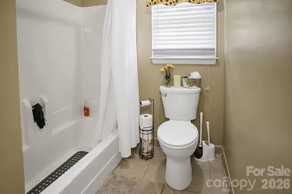 a white toilet sitting in a bathroom next to a sink
