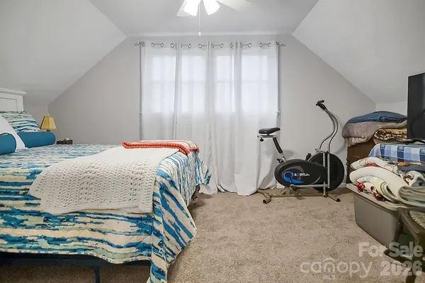 a bedroom with bed and a window