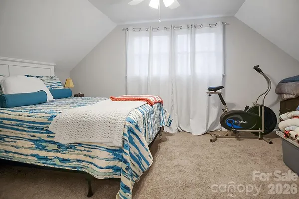 a bedroom with bed and a window