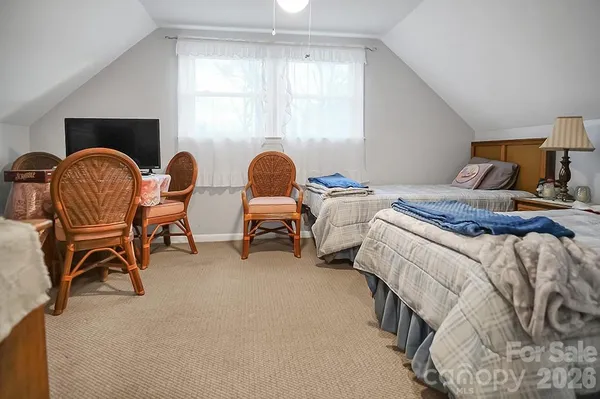 a bedroom with two beds and a window