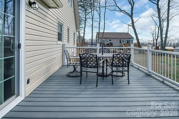 a view of a roof deck with table and chairs and wooden floor