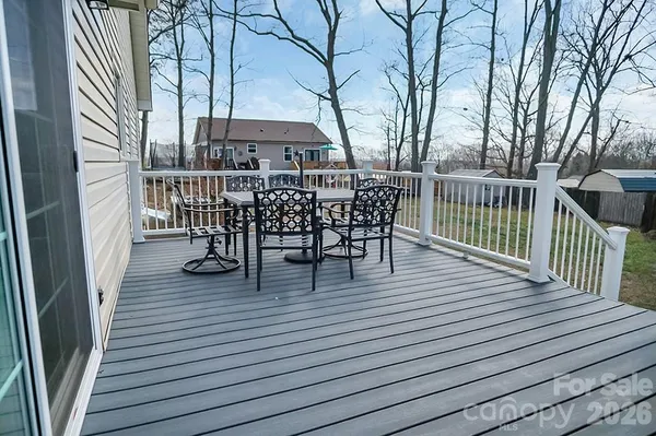 a view of a roof deck with table and chairs and wooden floor