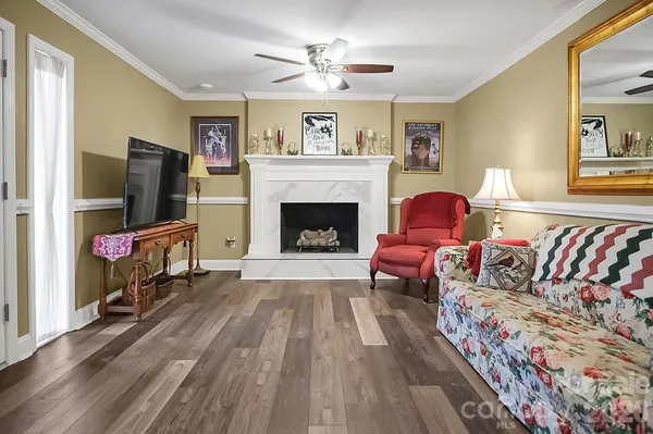 a living room with furniture fireplace and flat screen tv