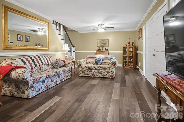 a bedroom with furniture and a wooden floor