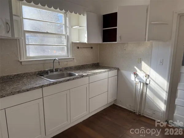 a kitchen with a sink and cabinets