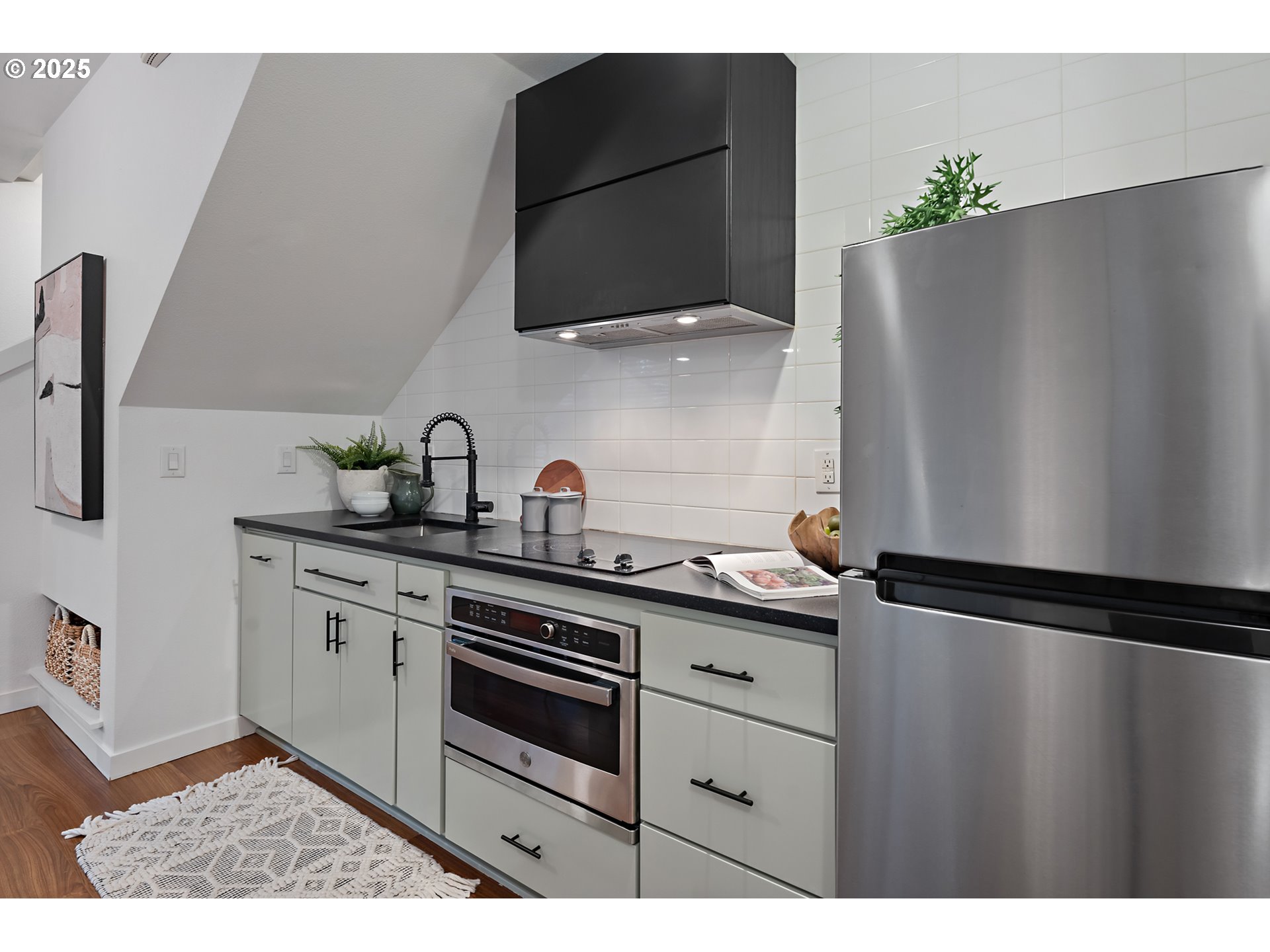 4303 Southeast Division Street Portland, OR 97206 - Photo 11 of 40 a kitchen with a refrigerator and cabinets