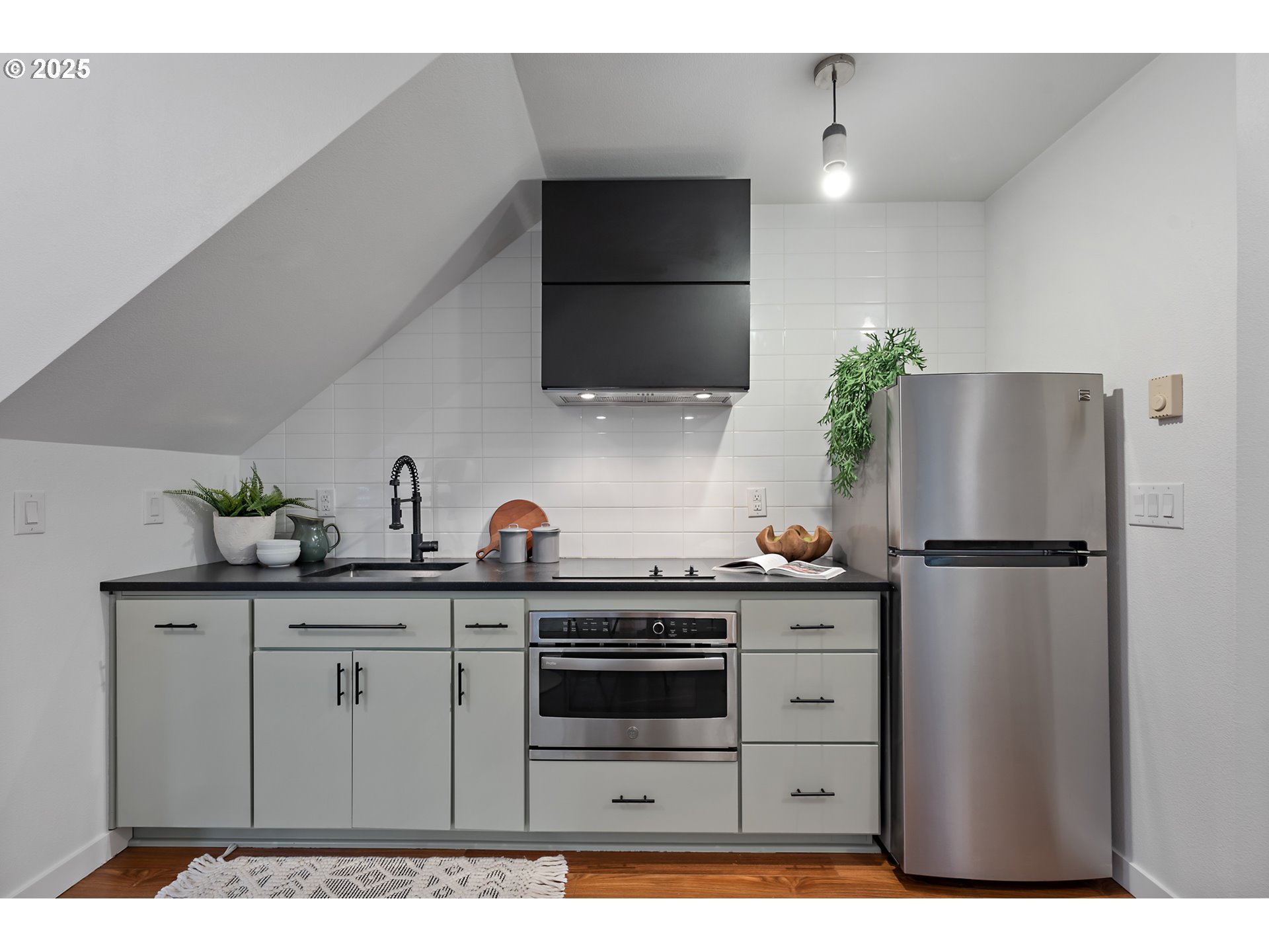 4303 Southeast Division Street Portland, OR 97206 - Photo 12 of 40 a kitchen with a sink a refrigerator and cabinets