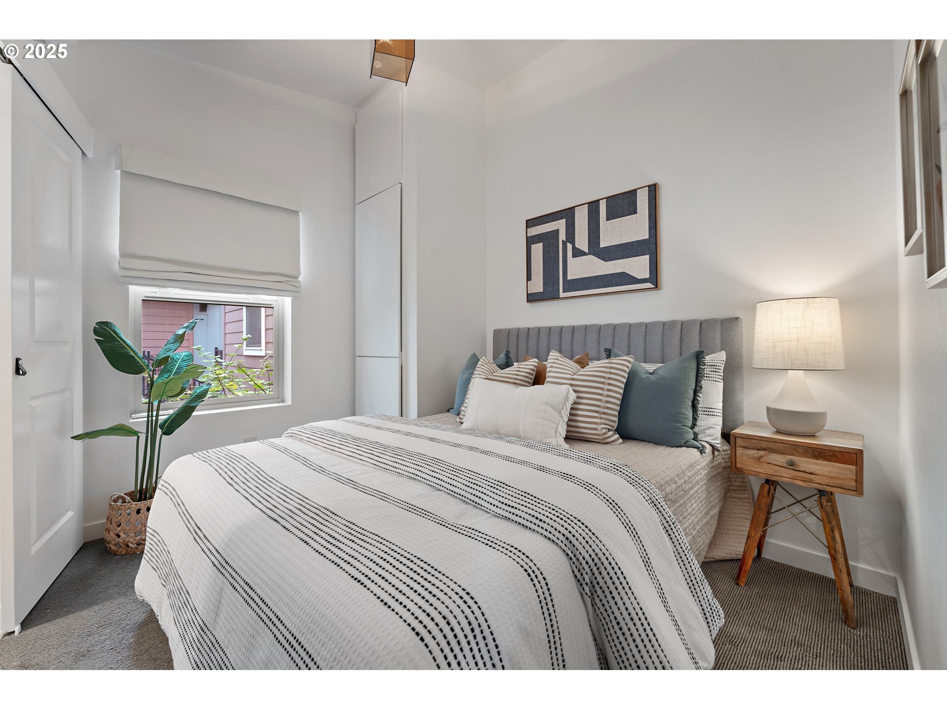 4303 Southeast Division Street Portland, OR 97206 - Photo 26 of 40 a bedroom with a bed table and a potted plant