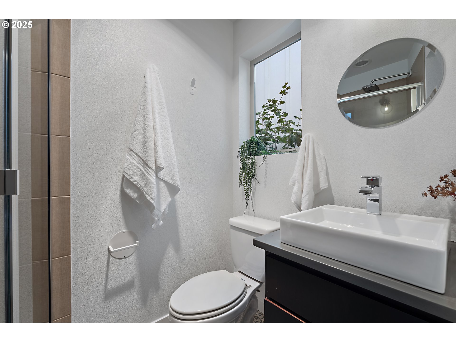 4303 Southeast Division Street Portland, OR 97206 - Photo 28 of 40 a bathroom with a sink a toilet and a mirror