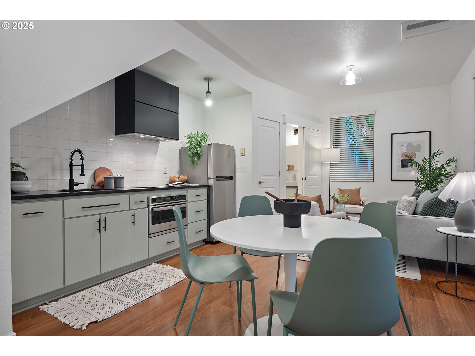 4303 Southeast Division Street Portland, OR 97206 - Photo 9 of 40 a kitchen with a table chairs sink and cabinets