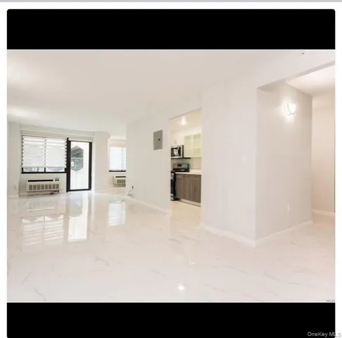 a view of a swimming pool with an outdoor seating and a floor to ceiling window