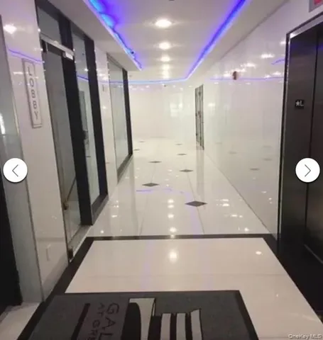 a view of a livingroom with furniture and a large window