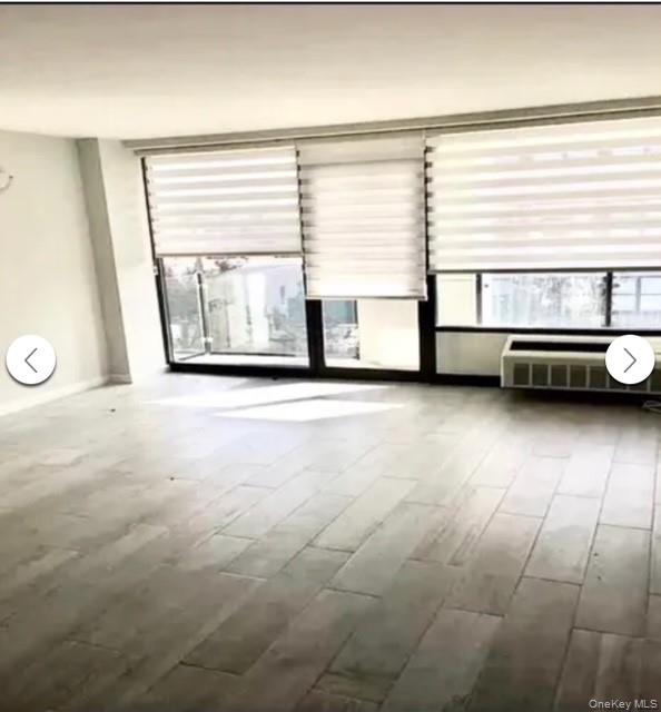 5 Grace Avenue, Unit 2J Great Neck, NY 11021 - Photo 5 of 15 a view of a livingroom with furniture and a large window