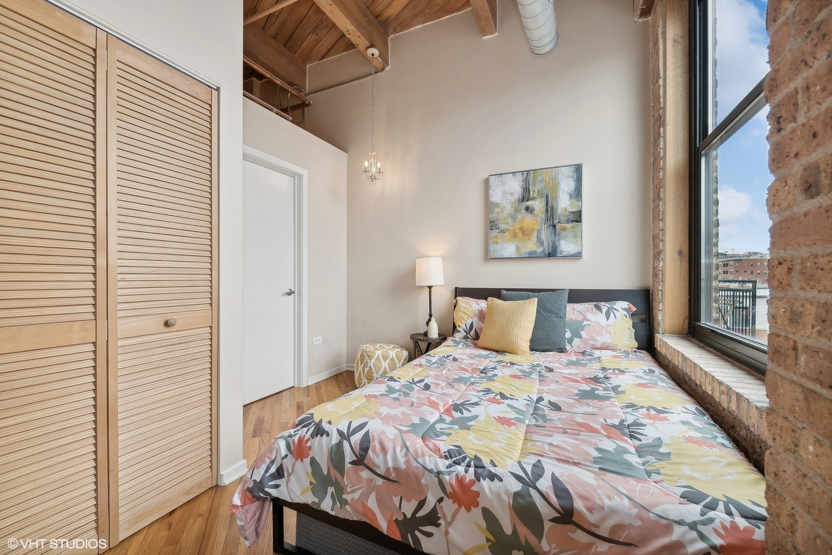 1040 West Adams Street, Unit 457 Chicago, IL 60607 - Photo 11 of 21 a bedroom with a bed and a window with a balcony