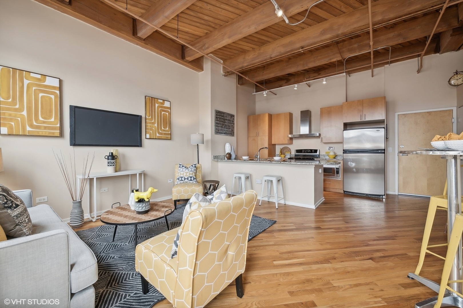1040 West Adams Street, Unit 457 Chicago, IL 60607 - Photo 5 of 21 a living room with stainless steel appliances kitchen island granite countertop furniture and a wooden floor