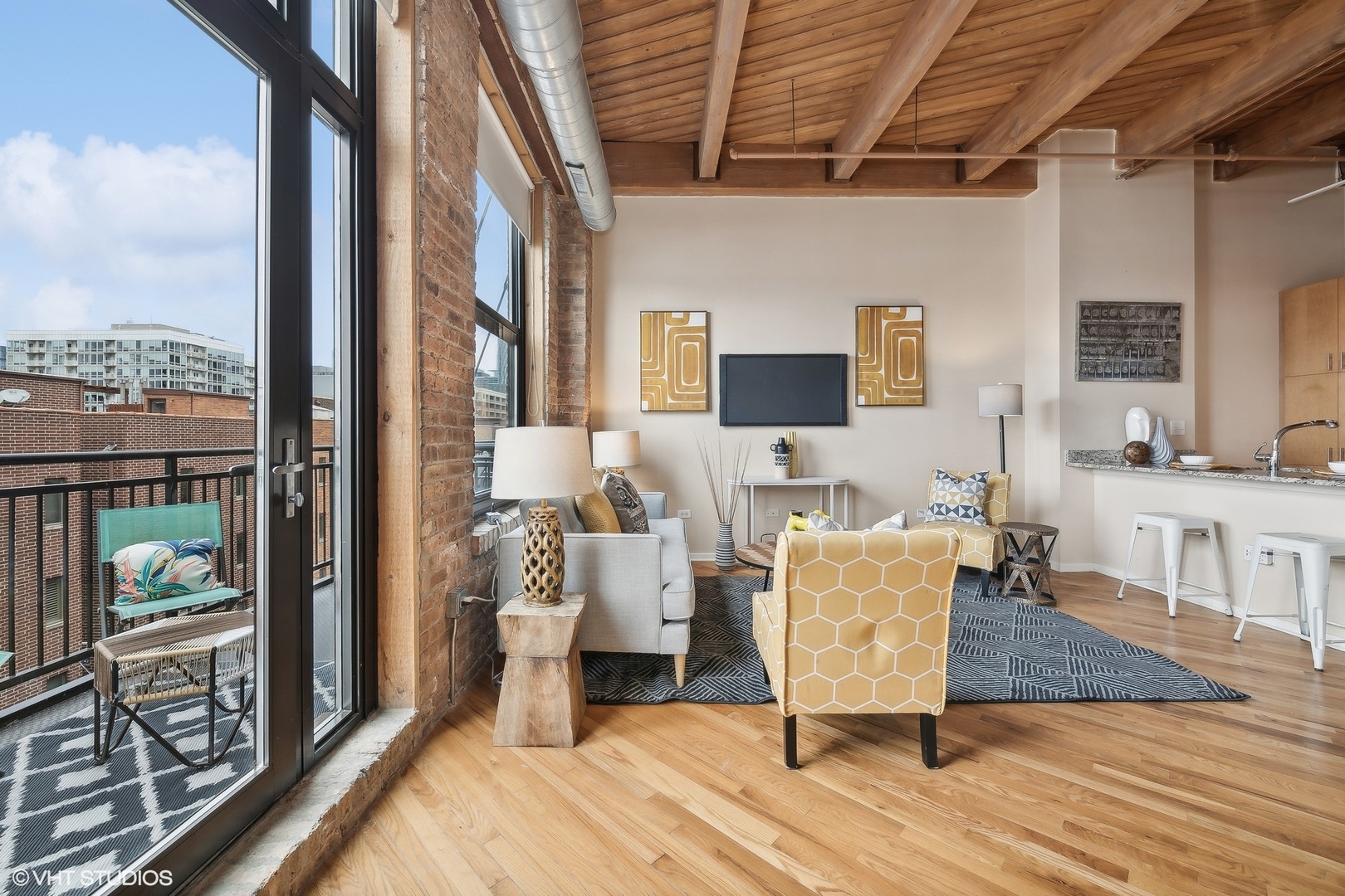 1040 West Adams Street, Unit 457 Chicago, IL 60607 - Photo 6 of 21 a living room with furniture a fireplace and a flat screen tv