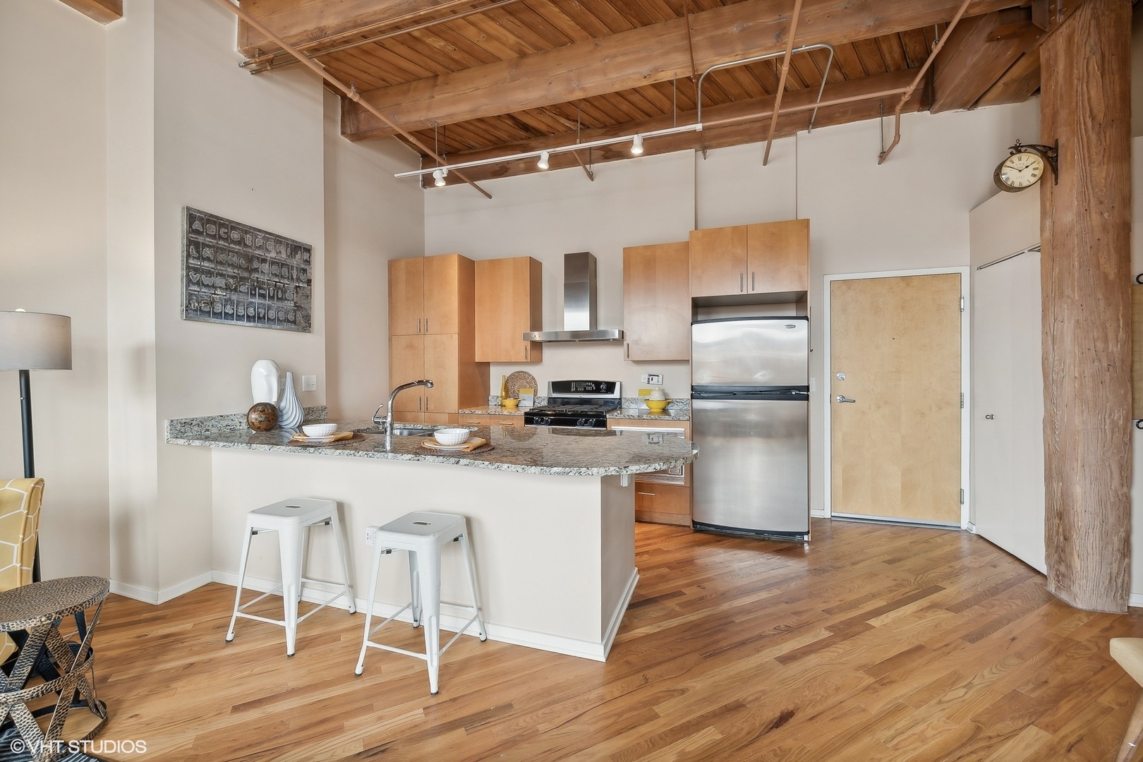 1040 West Adams Street, Unit 457 Chicago, IL 60607 - Photo 8 of 21 a kitchen with granite countertop a refrigerator and wooden floor