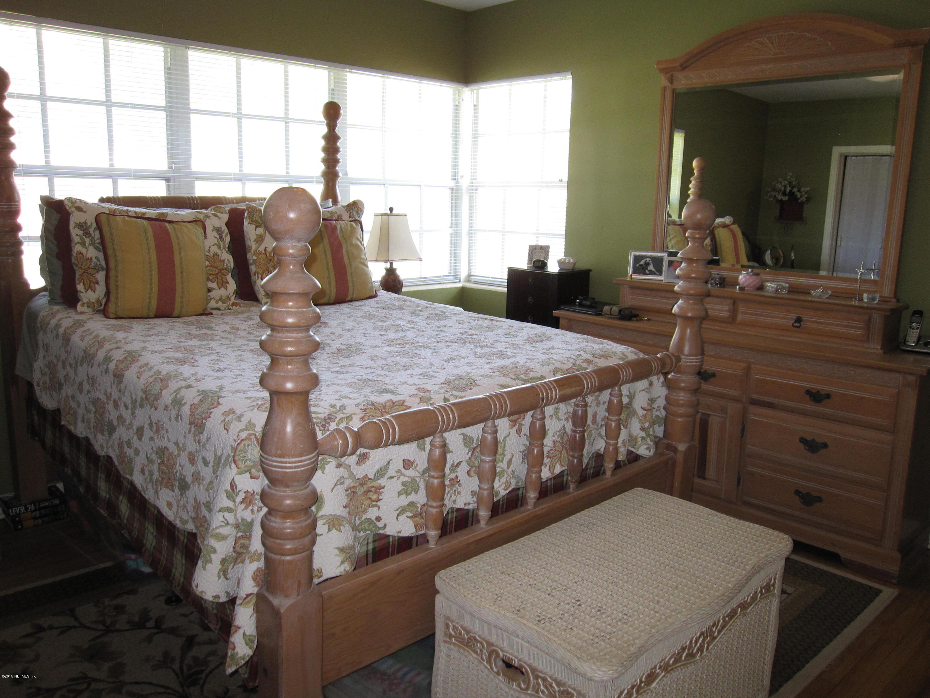 6416 Wesleyan Road Jacksonville, FL 32217 - Photo 11 of 35 a bed sitting in a bedroom next to a window