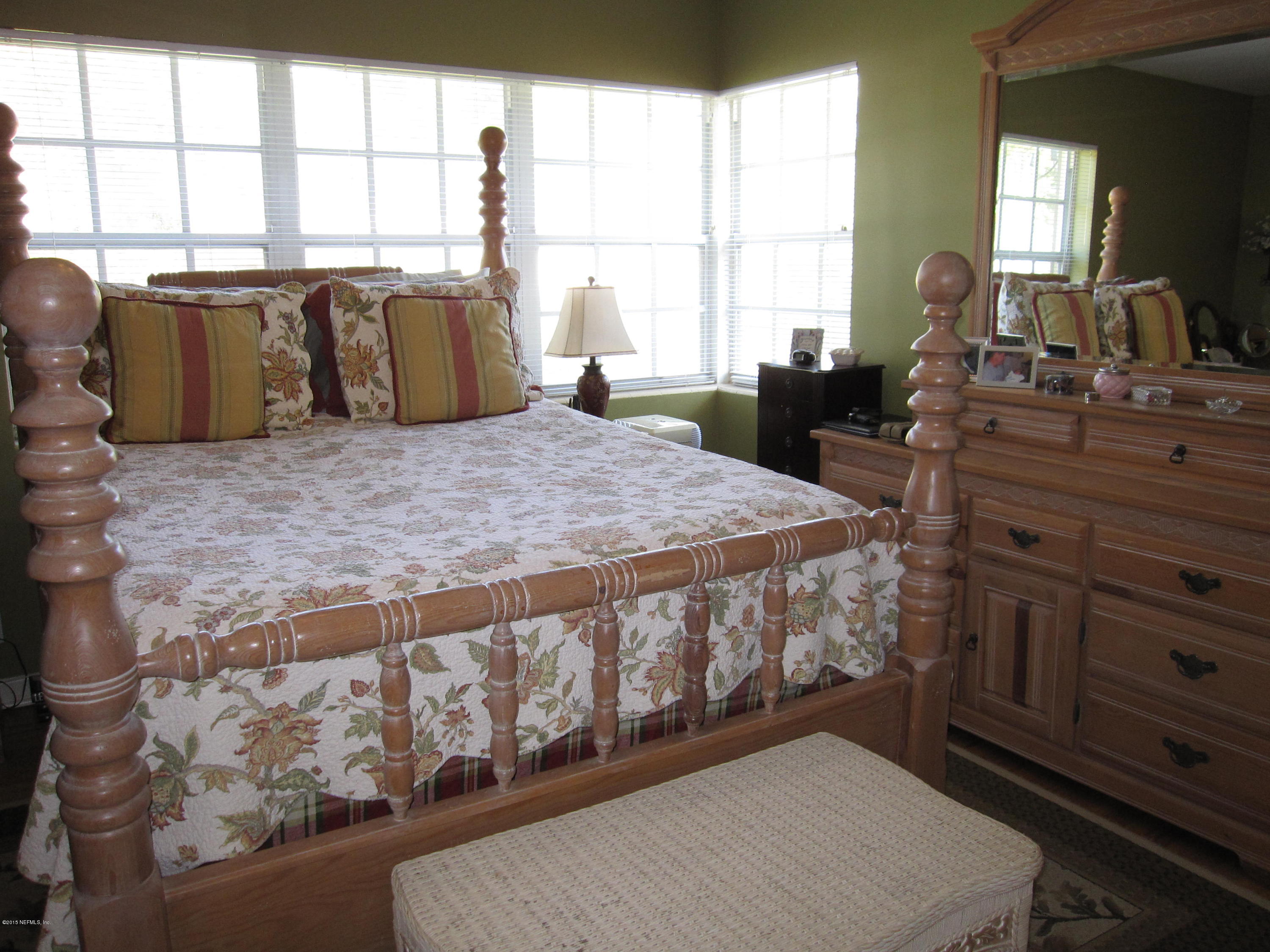6416 Wesleyan Road Jacksonville, FL 32217 - Photo 12 of 35 a bed sitting in a bedroom next to a window