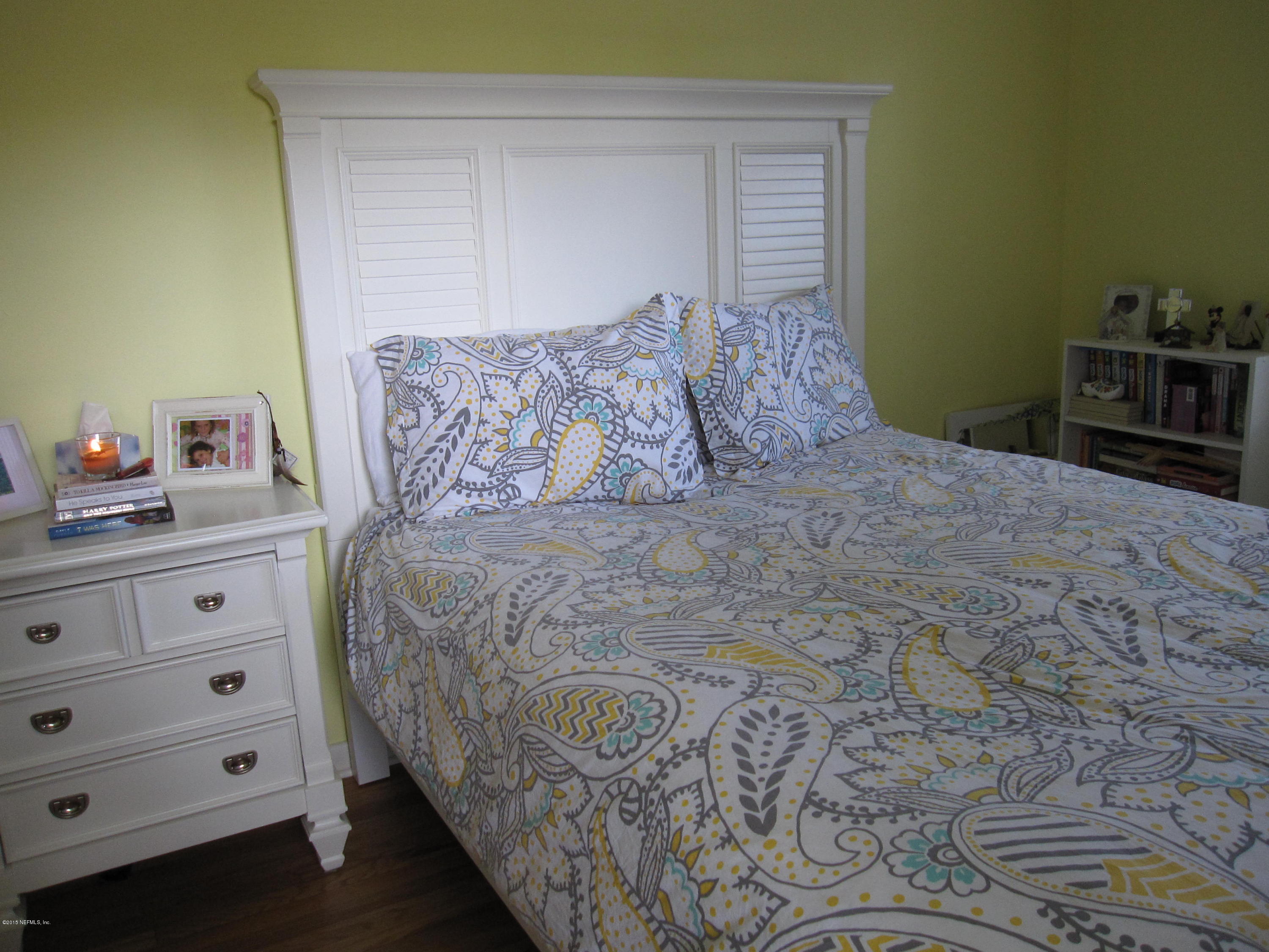 6416 Wesleyan Road Jacksonville, FL 32217 - Photo 13 of 35 a large bed sitting in a bedroom next to a cabinet