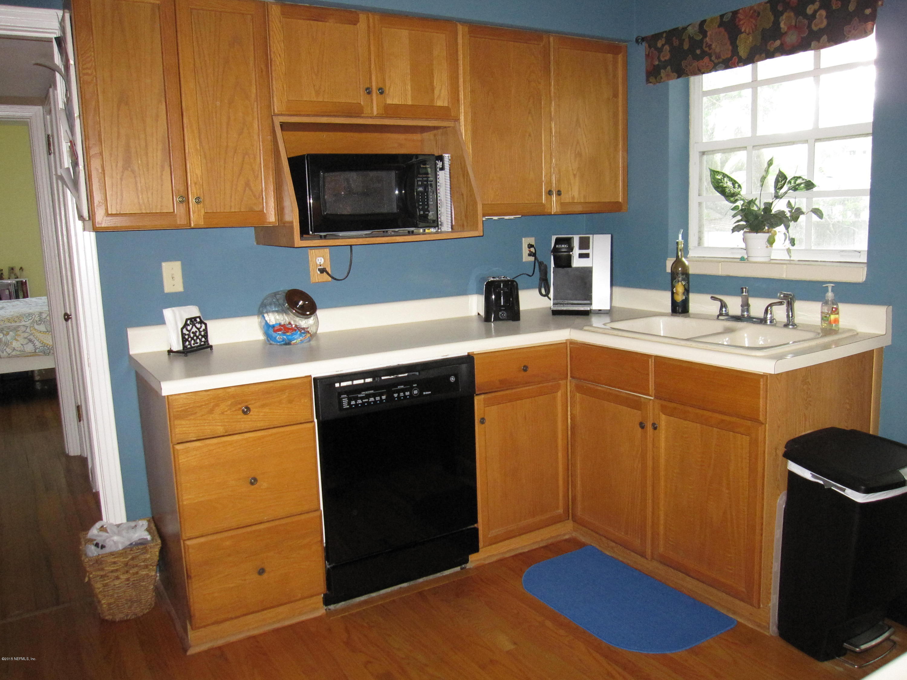 6416 Wesleyan Road Jacksonville, FL 32217 - Photo 24 of 35 a kitchen with a sink stove and cabinets