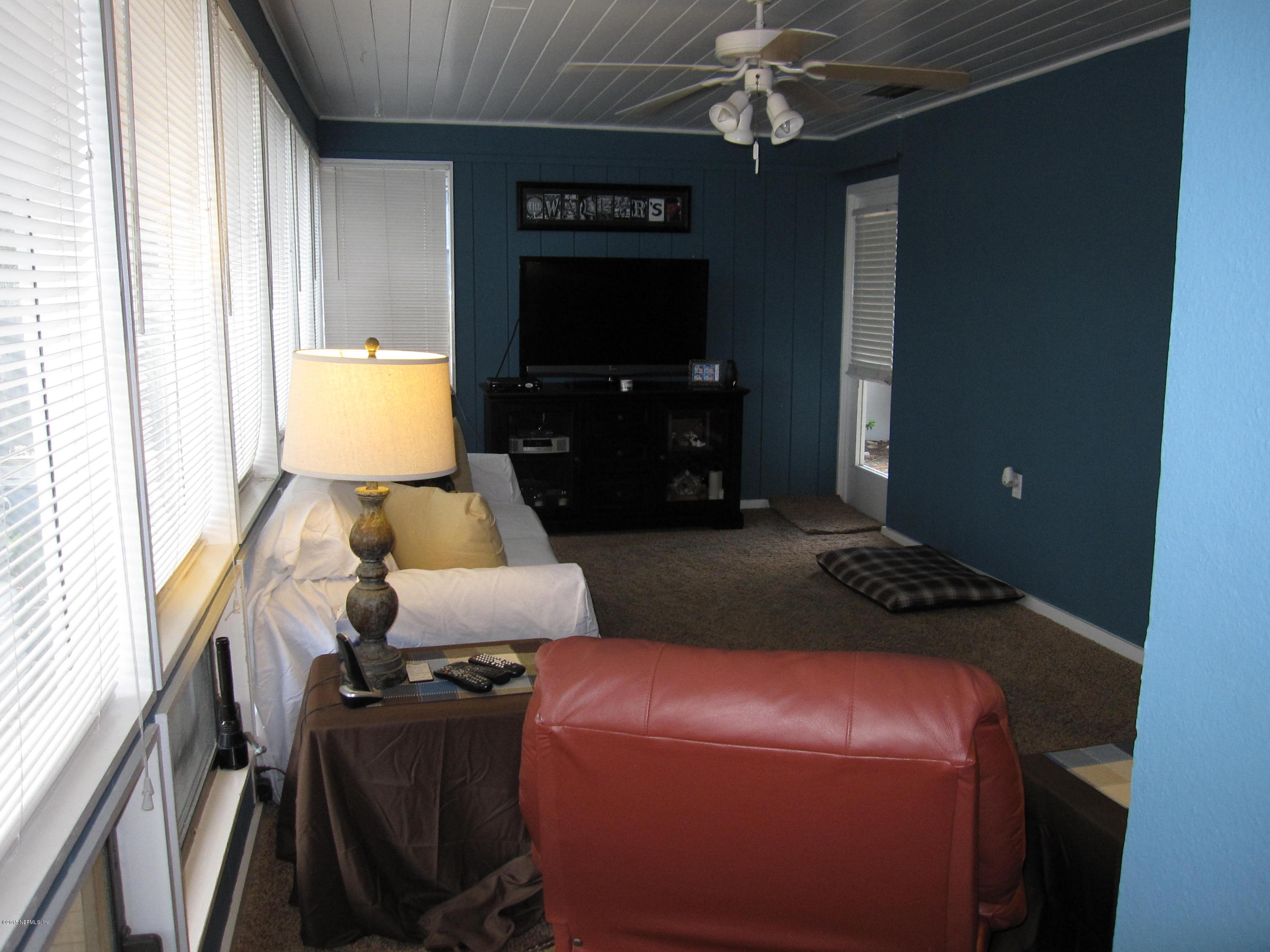 6416 Wesleyan Road Jacksonville, FL 32217 - Photo 26 of 35 a living room with furniture and a flat screen tv