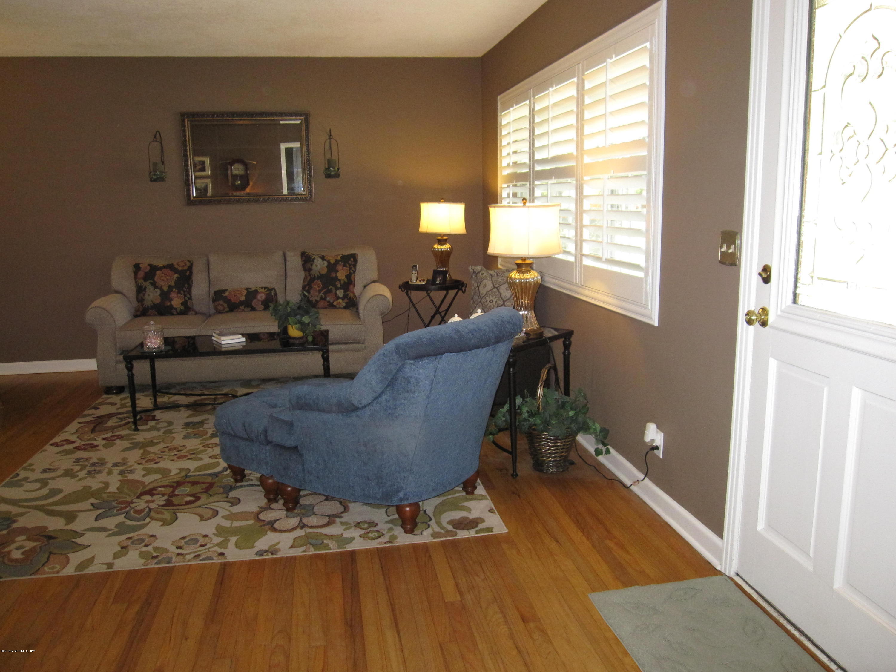 6416 Wesleyan Road Jacksonville, FL 32217 - Photo 7 of 35 a living room with furniture and a large window