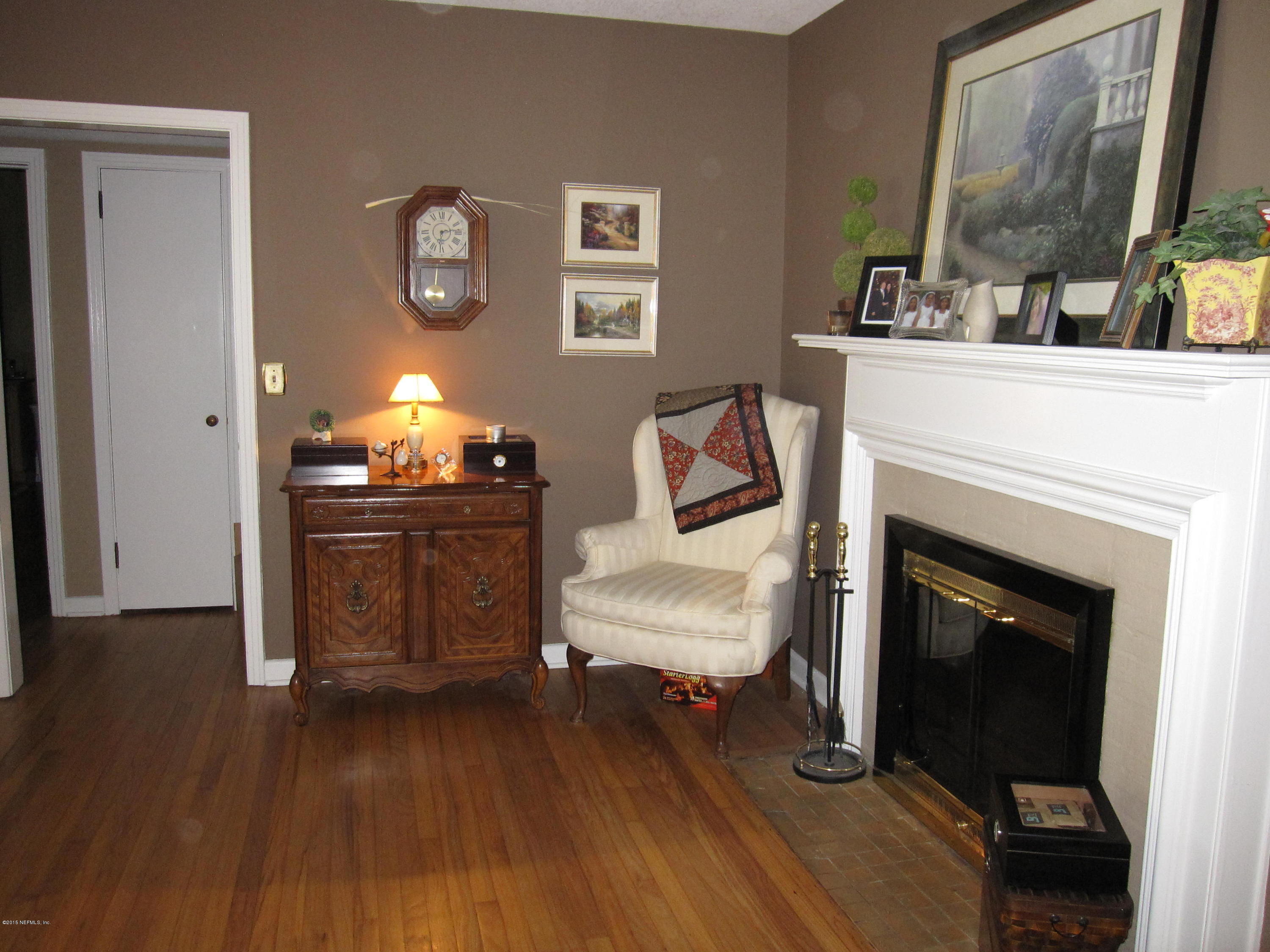 6416 Wesleyan Road Jacksonville, FL 32217 - Photo 10 of 35 a living room with furniture and a fireplace