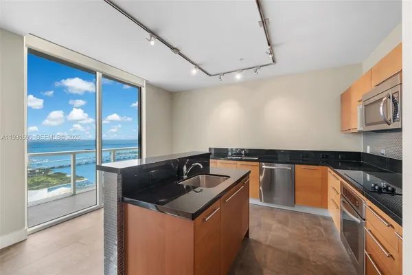 a kitchen that has a sink and a stove
