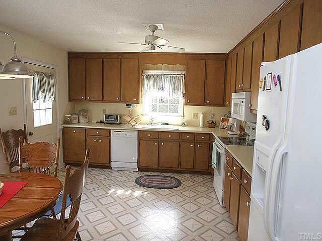 5700 Roslyn Road Durham, NC 27712 - Photo 4 of 9 a kitchen with a sink window and cabinets