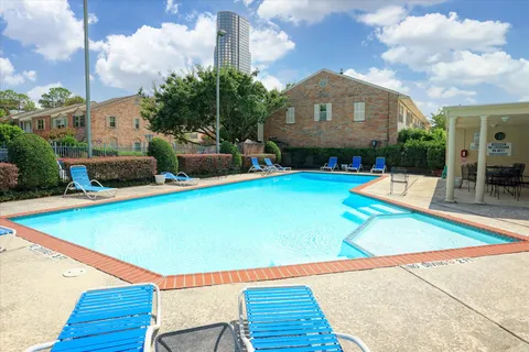 a view of a swimming pool with a lounge chairs