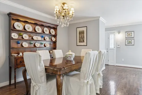 a view of a dining room with furniture and chandelier