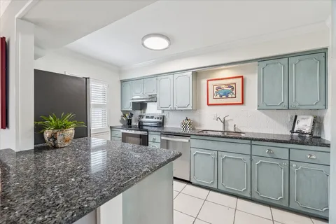 a kitchen with sink and cabinets