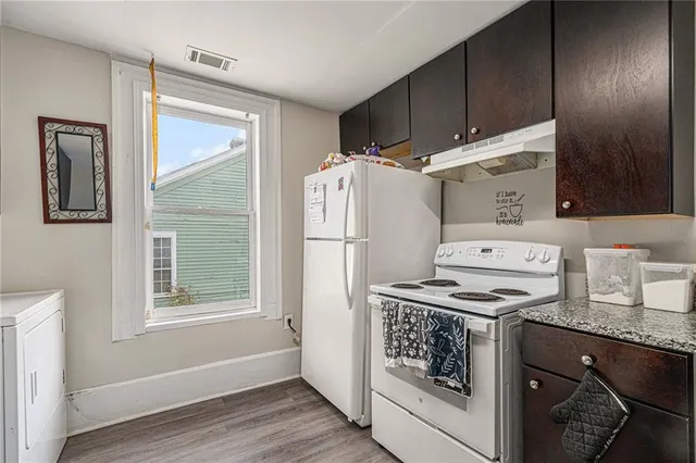 a kitchen with a refrigerator stove and sink