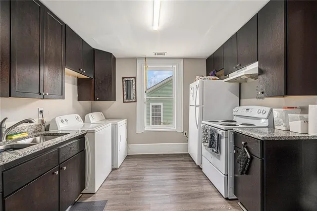 a kitchen with a sink stove and refrigerator