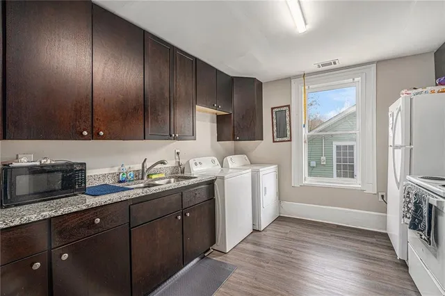 a kitchen with a sink wooden cabinets and stainless steel appliances