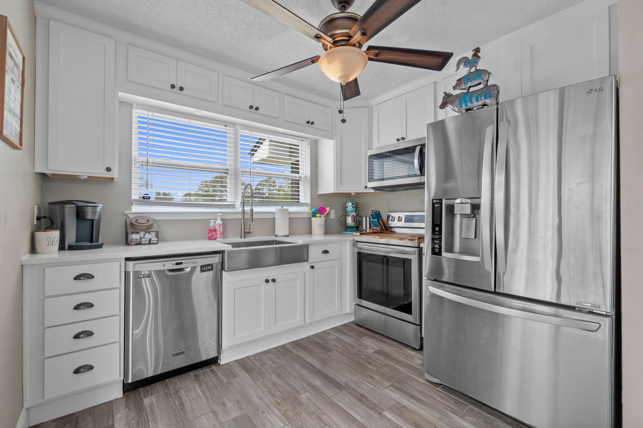 1833 Hunters Path Fort Walton Beach, FL 32547 - Photo 11 of 34 a kitchen with stainless steel appliances a refrigerator sink and cabinets