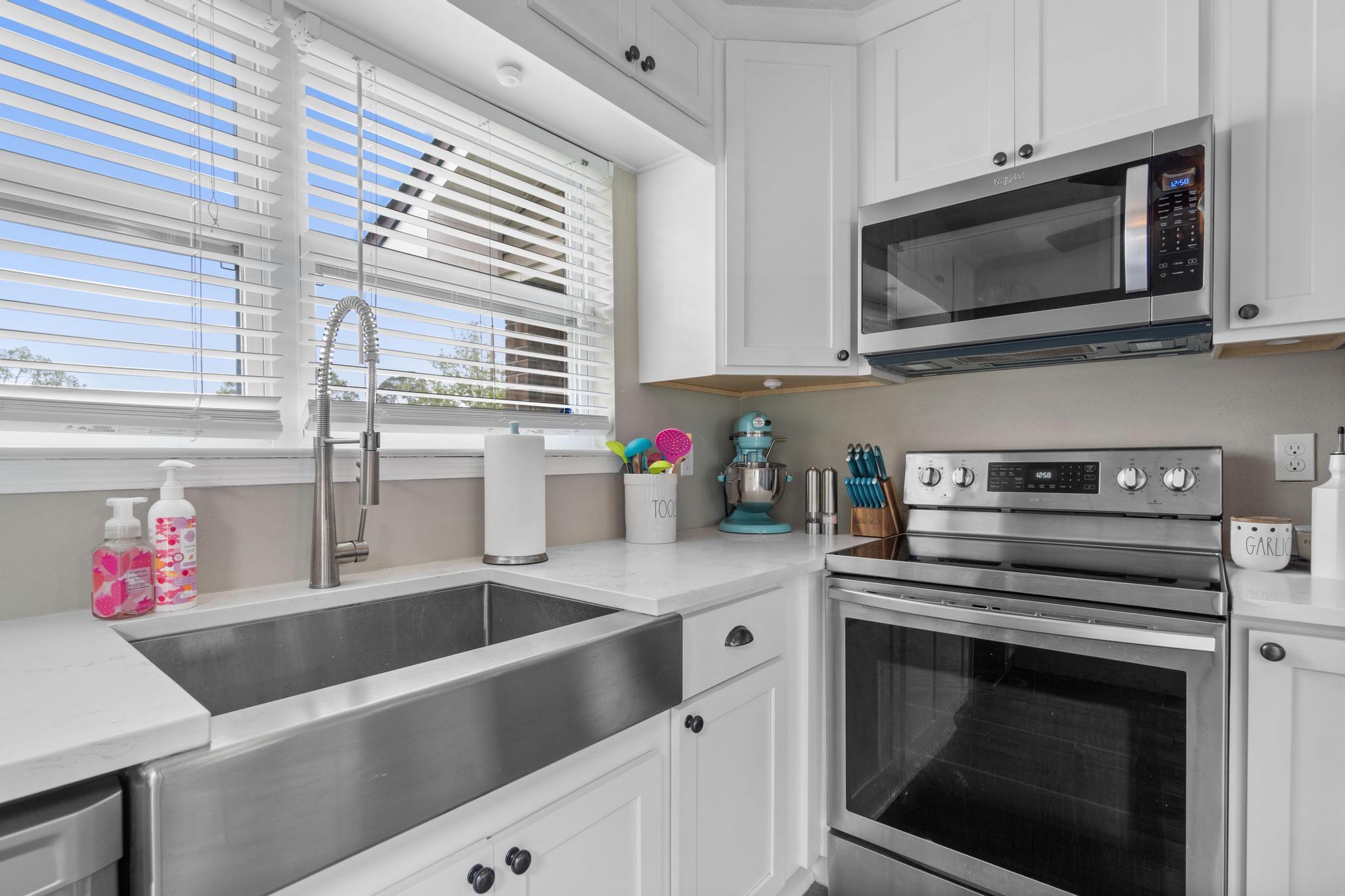 1833 Hunters Path Fort Walton Beach, FL 32547 - Photo 12 of 34 a kitchen with granite countertop a sink stainless steel appliances and cabinets